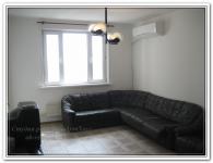 Ремонт помещения гостиной с черным кожаным диваном
